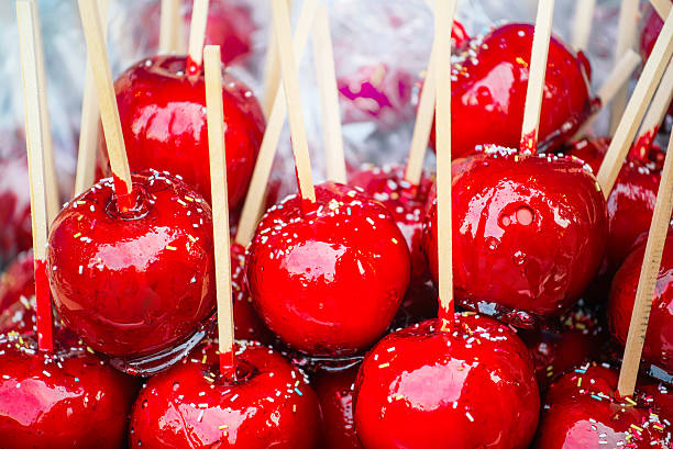 Sweet glazed red toffee candy apples on sticks