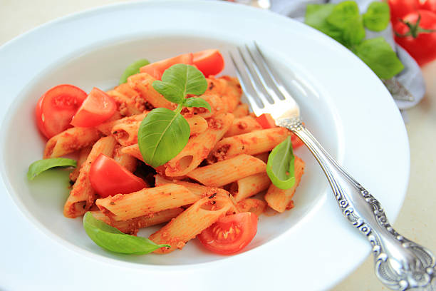 Penne pasta with fresh tomato stock photo