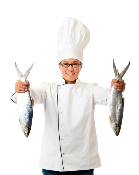 Funny Chef Man Holding Plate Serving Fish Dish Standing On Black Studio Background. Panorama, High-Angle Shot