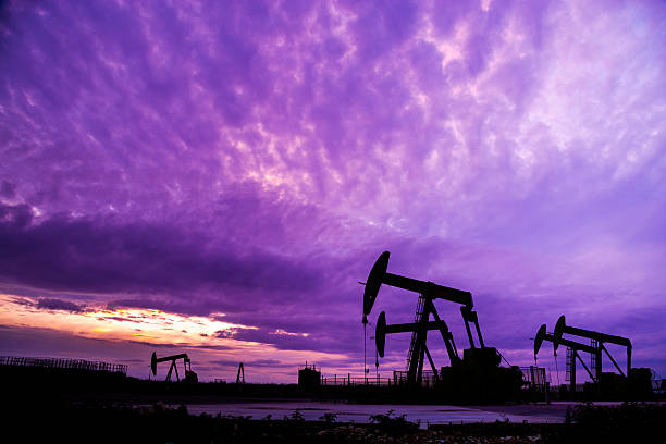 Silhouette of Oil pumps at oil field Silhouette of Oil pumps at oil field with nice sunset sky background natural gas extraction stock pictures, royalty-free photos & images