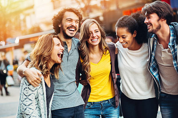 Group of friends on the street Multi-ethnic group of people walking and laughing outdoors in the city. street friends stock pictures, royalty-free photos & images