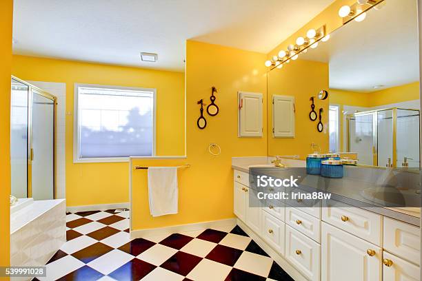 Bright Yellow Bathroom Interior With White Cabinets Tile Stock Photo - Download Image Now