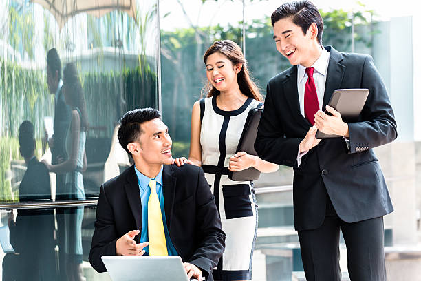 istock Asian businesspeople working outside on laptop 540089882
