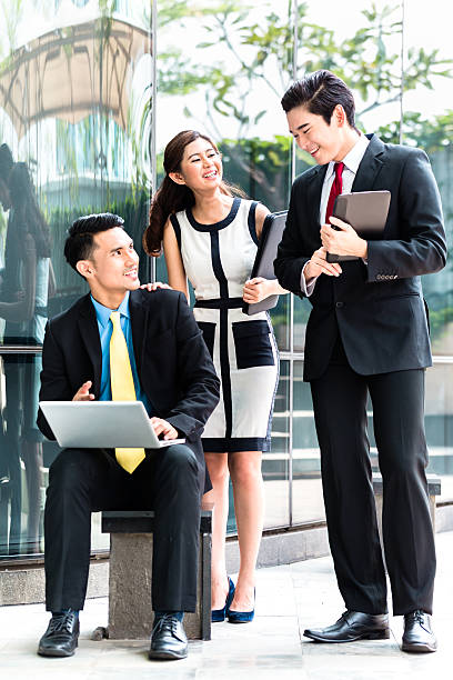 istock Asian businesspeople working outside on laptop 540089970