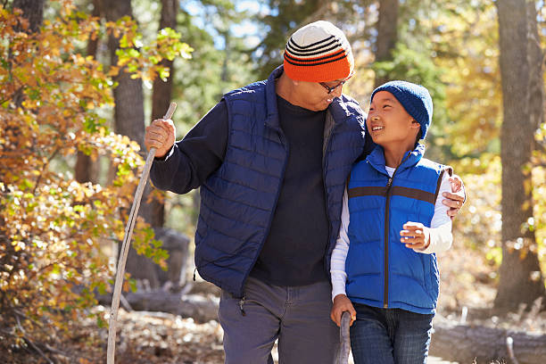 istock Dad and son hiking in forest embrace looking at each 540090190