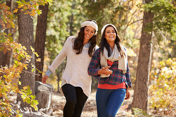 istock Lesbian couple walk holding hands in a forest, close up 540090312