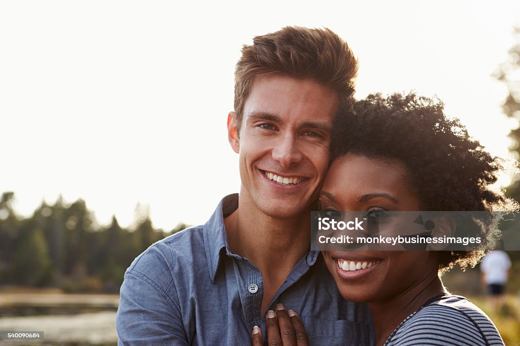 Mixed race couple in the countryside, looking to camera Couple - Relationship Stock Photo