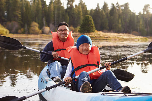 istock Father and son kayaking on a rural lake, front view 540090688