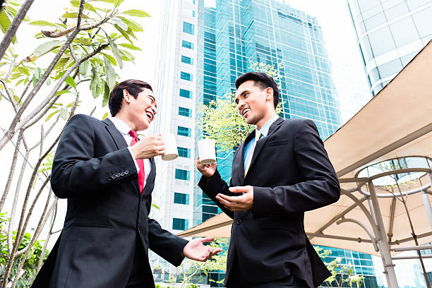 istock Asian businesspeople drinking coffee outside 540092748