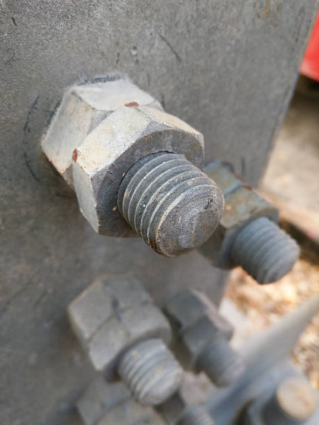 istock Heavy duty metal nuts and bolt holding steel structure together 540093044