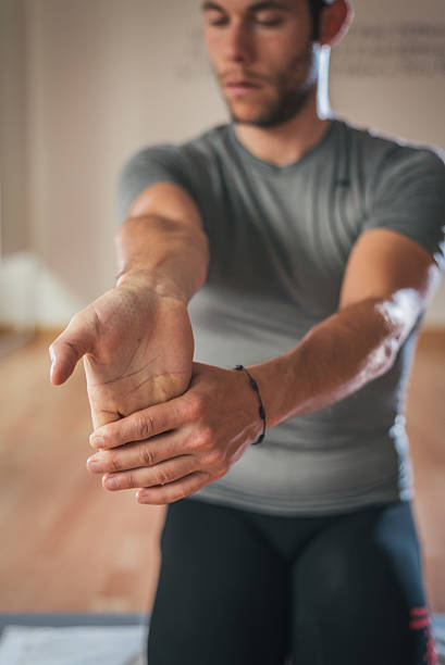 istock Sporty man stretching forearm before gym workout 540094820