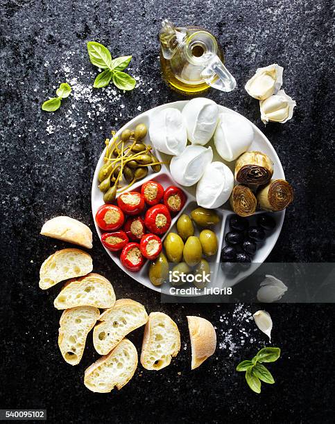 Pletter Appetizer Of Green Olives Black Olives Capers Buffalo Stock Photo - Download Image Now