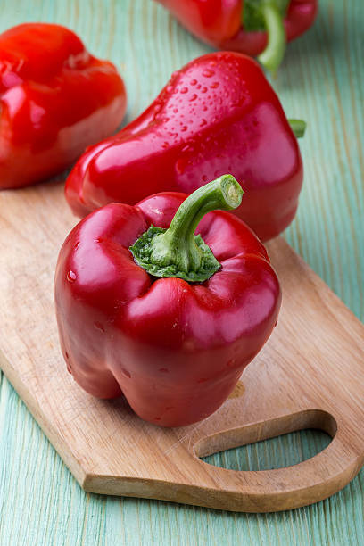 istock Fresh organic bell peppers on a wooden board 540095108