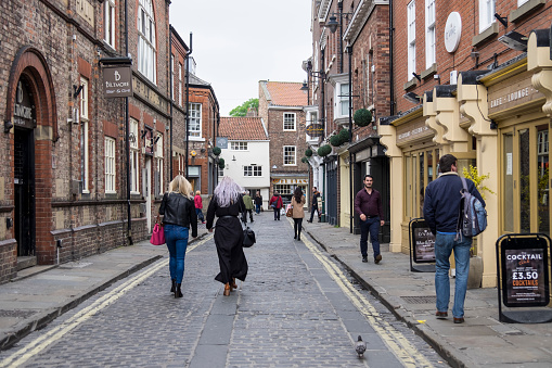 York, England - May 27, 2016: Two unidentidied women strolling through the old streets of York