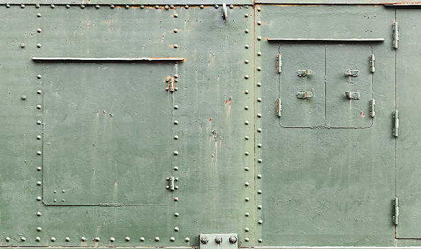 Old metal background texture with manholes Abstract green industrial metal background texture with manholes, bolts and rivets, details of Russian armored train from WWII time riveted metal texture stock pictures, royalty-free photos & images