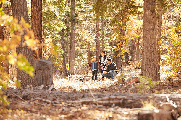 istock Father talking with his children in a forest 540095954