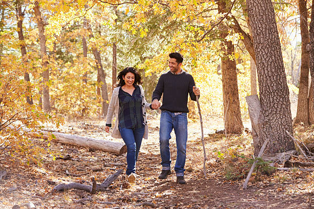 istock Smiling Hispanic couple walk in a forest holding hands 540096064
