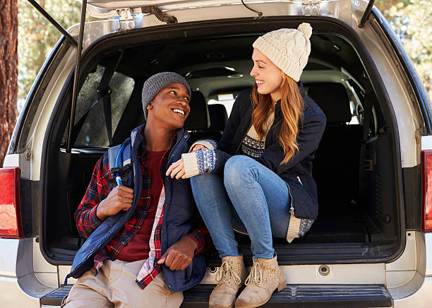 istock Mixed race couple in open back of car looking at each 540096108