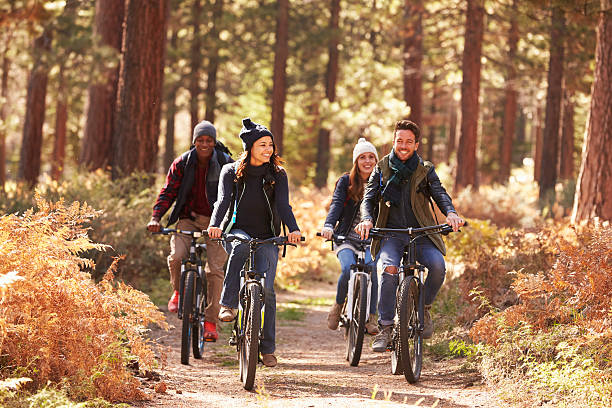 istock Group of friends on bikes in forest front view 540096228