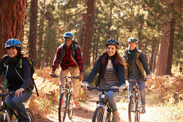 istock Group friends in helmets riding bikes in a forest, close up 540096232