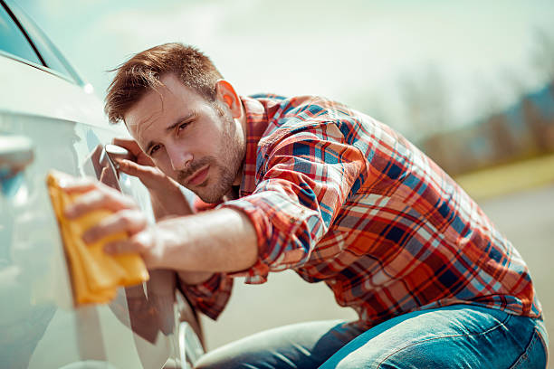 istock Man with a microfiber wipe the car polishing 540096312