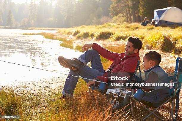 Father And Son On A Camping Trip Fishing By A Lake Stock Photo - Download Image Now - Camping, Fishing, Autumn
