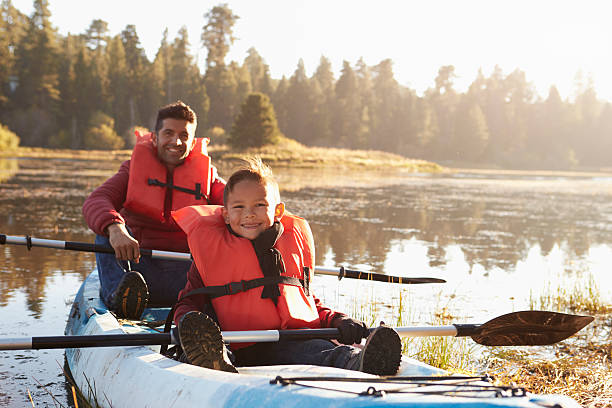 istock Father and son kayaking on rural lake, close up 540096528