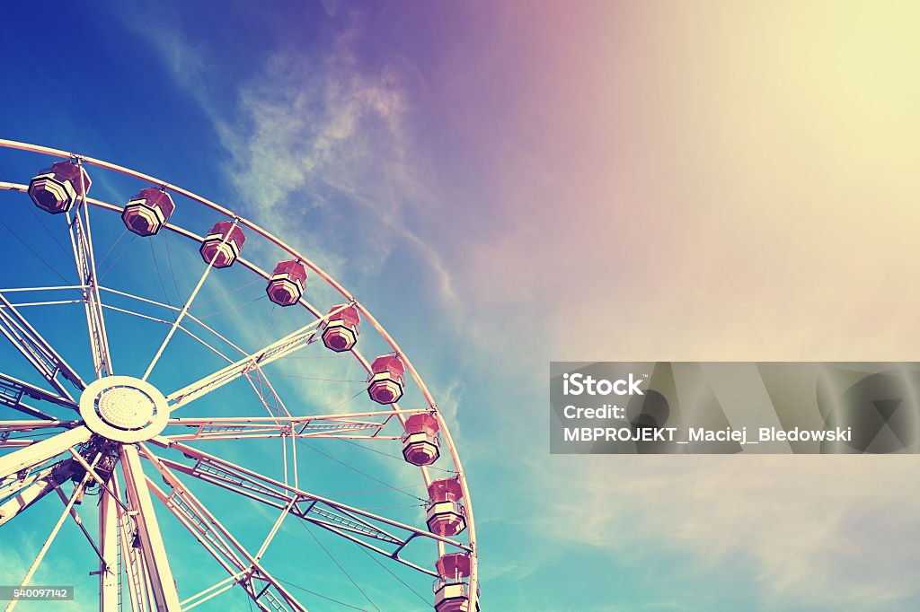Vintage stylized ferris wheel at sunset. Vintage stylized ferris wheel at sunset, space for text. Amusement Park Stock Photo