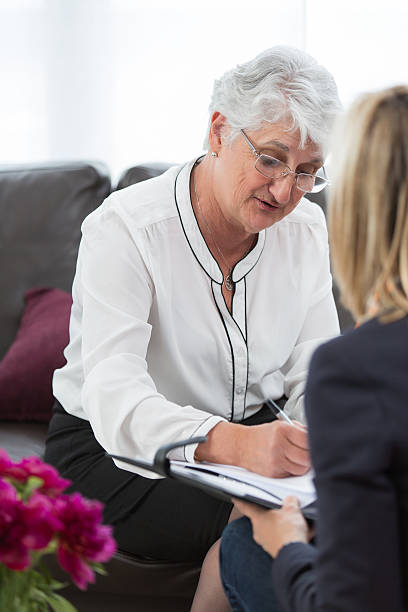 istock Senior with Real Estate Agent signing mortgage contract 540097458