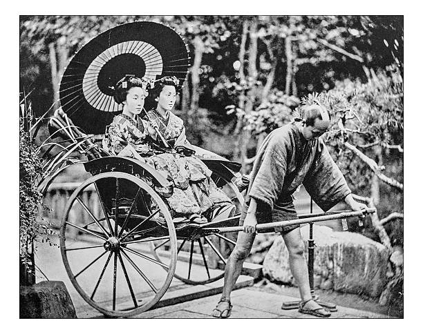 Antique photograph of Japanese jinricksha - end of 19th century Antique photograph of a Japanese jinricksha (jin rick sha or jin riki sha) at the end of the 19th century: a small, two-wheeled carriage carried by a person (a pulled rickshaw) and carrying two young Japanese women. All people wear traditional Japanese costumes and wagasa. horse cart photos stock illustrations