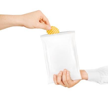 Blank white snack bag mock up hold in hand isolated. Clear white chips pack mockup. Eating chips. People treat chips and crisps. Men taking potato chips from opened packaging. Friend sharing food.