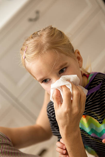 istock Little girl is blowing one´s nose 540105562