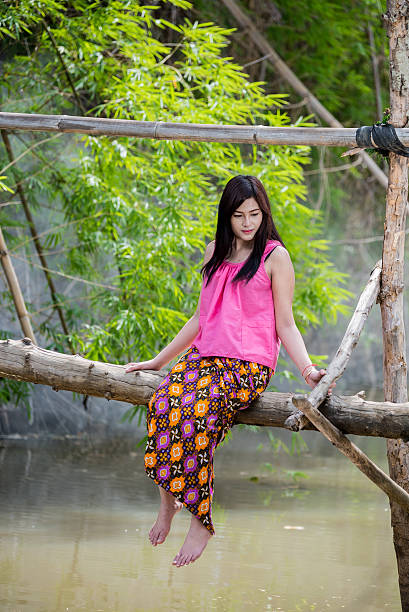 istock Young woman is sitting on wooden bridge . 540106008