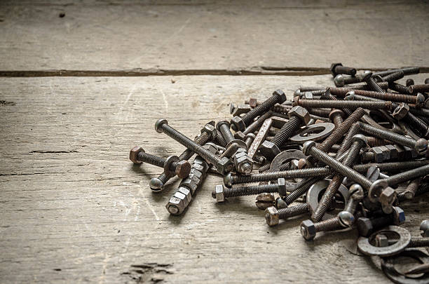 istock Old rusty metal screws on an hardwood workbench 540106718