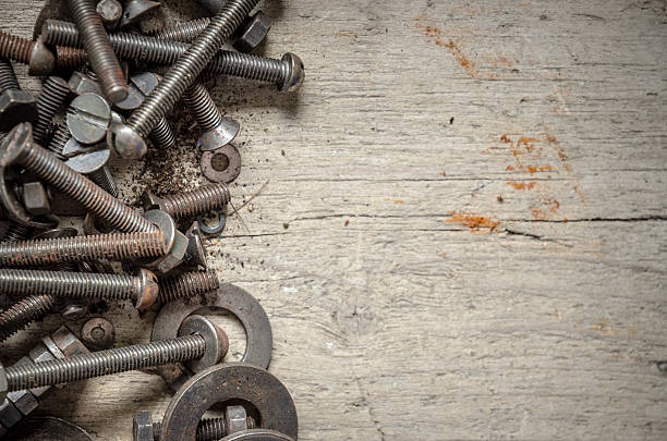 istock Old rusty metal screws with copy space on hardwood workbench 540106802