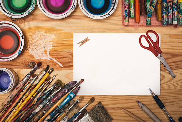 istock Creative painting workshop tools on wooden board with paper sheet 540111472
