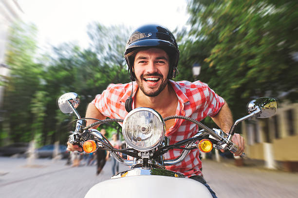 istock Handsome man riding a scooter on city streets 540112124