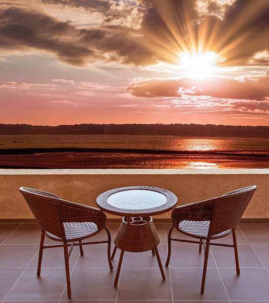 istock Table and chairs on a terrace, view on a beach 540114946