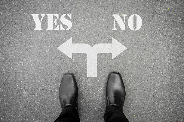 Black shoes at the crossroad - yes or no Businessman in black shoes standing at the crossroad making decision which way to go - yes or no single word no stock pictures, royalty-free photos & images