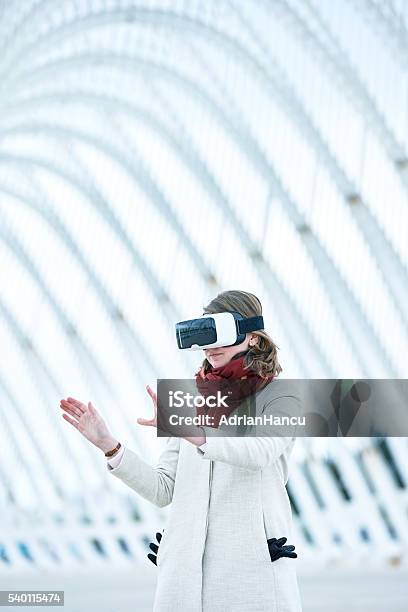 Woman Wearing A Virtual Reality Headset Controlling The Experie Stock Photo - Download Image Now