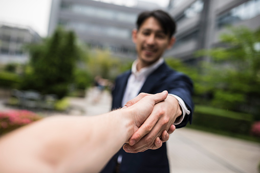 A POV shot of two people shaking hands