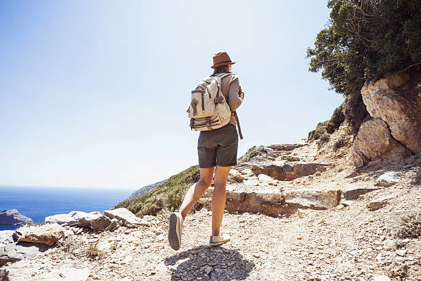 Young woman hiker on mountain trail, travel and active lifestyle concept