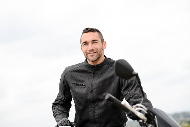 istock handsome young man riding his black motorcycle 540121522