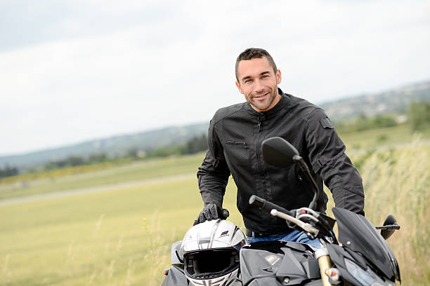 istock handsome young man riding his black motorcycle 540121786
