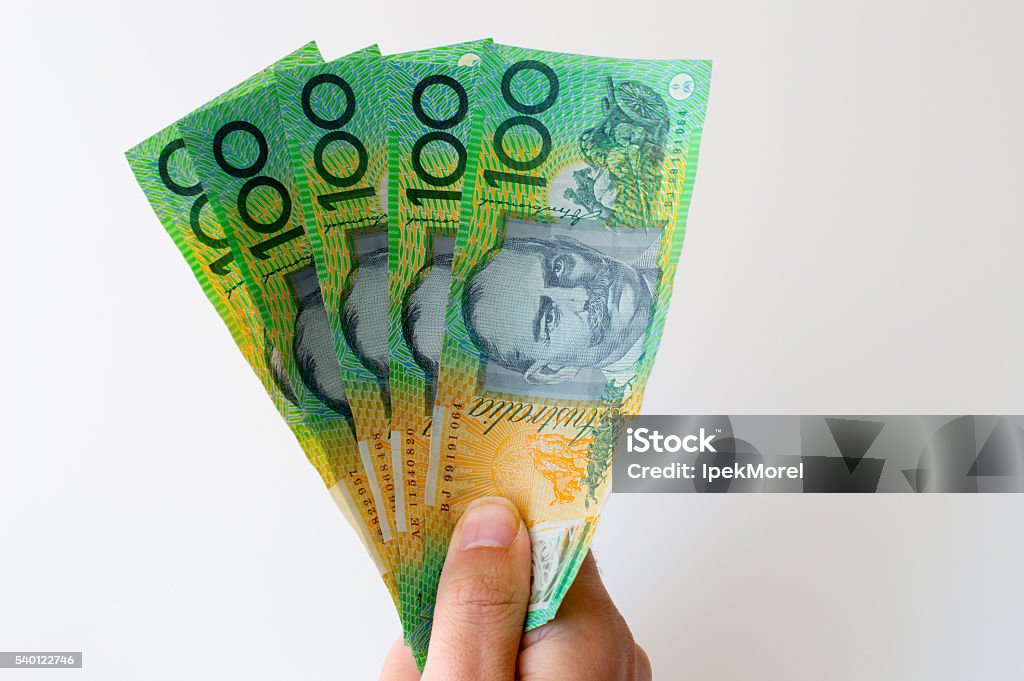 Man holding five hundred Australian Dollar banknote in his hands Man holding five hundred Australian Dollar banknote in his handsMan holding five hundred Australian Dollar banknote in his hands Paper Currency Stock Photo