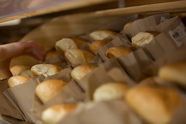istock At the bakery. Shelf with loaves of white bread 540123118