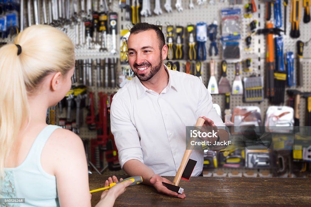 ï»¿customer getting help at pay desk ï»¿Female customer getting help at pay desk in household store from happy seller Store Stock Photo