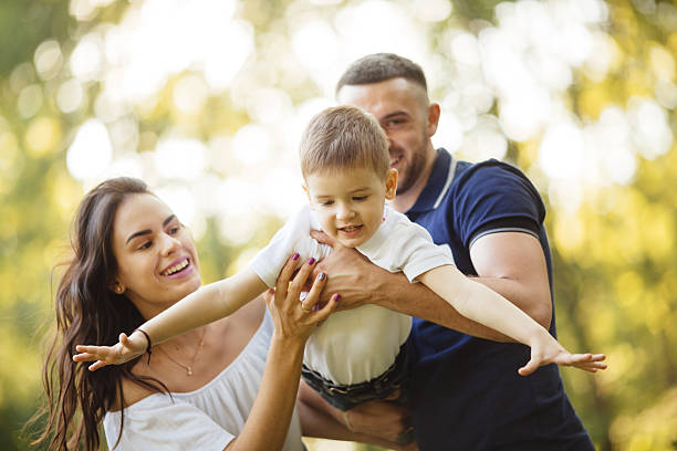 istock Mother and father make their happy  son to fly. 540126610