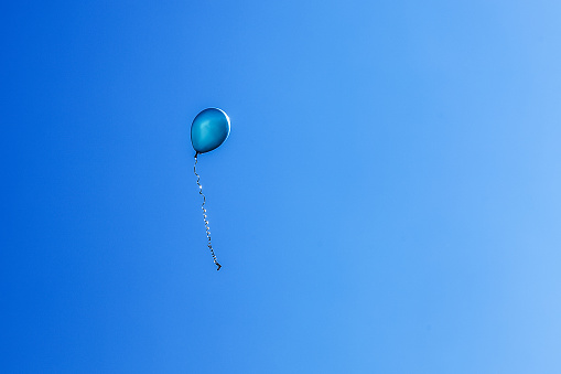 One blue balloon in the sky