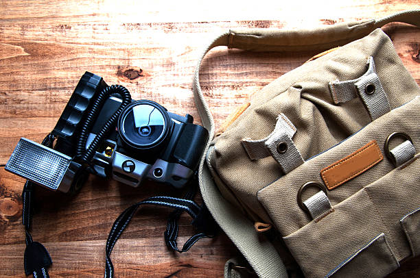 istock Old camera and bag, wooden background 540127680